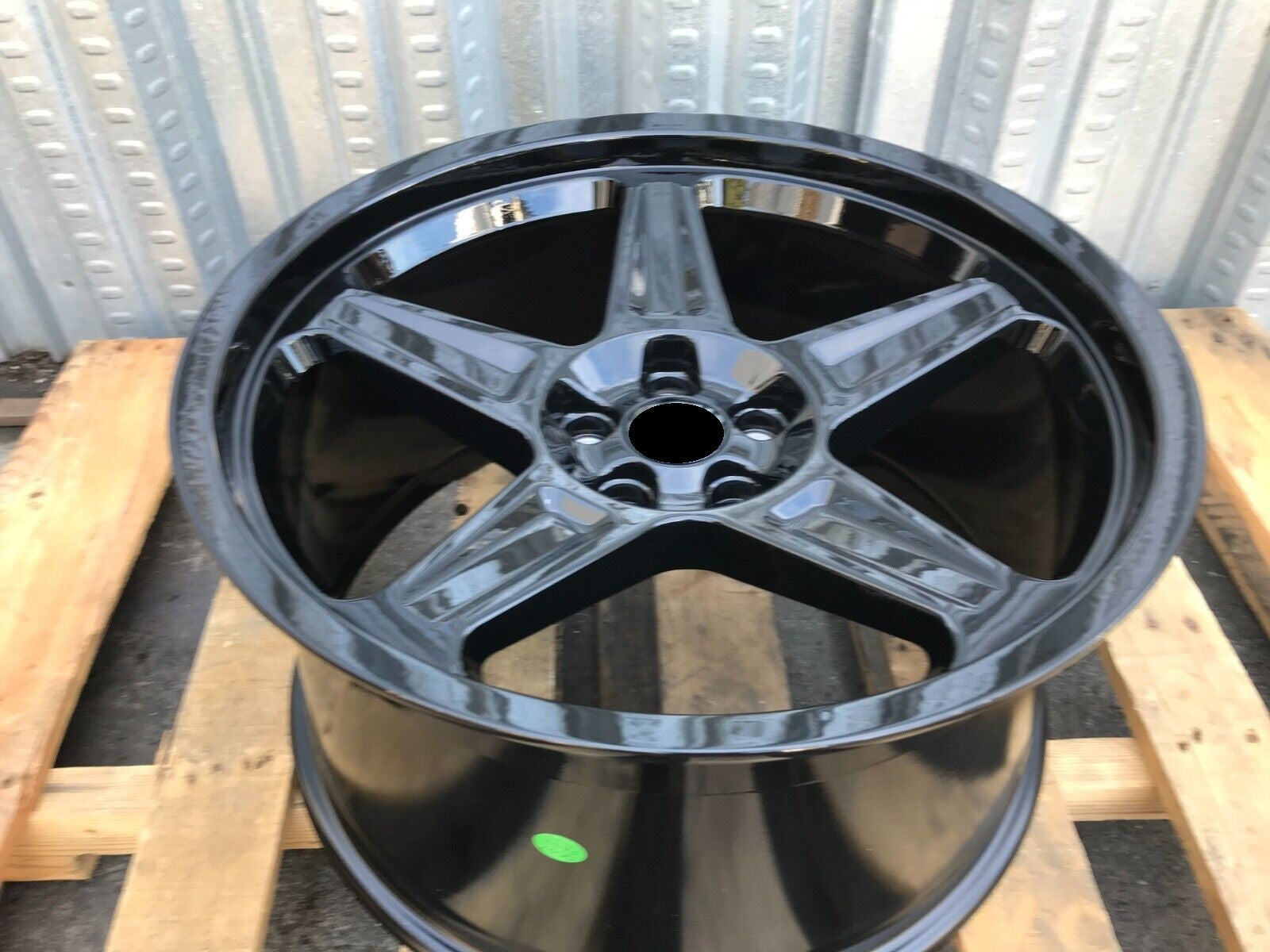 20-inch Demon Style gloss black wheels by OE Style Wheels on a Dodge Challenger or Charger, showcasing a sleek, aggressive automotive rim design.