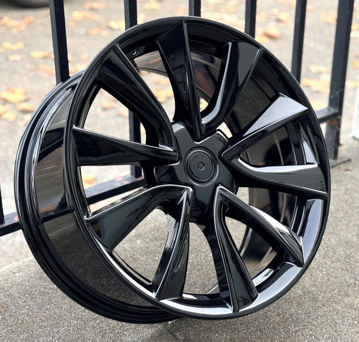22-inch gloss black OE Style Wheels automotive rims fitting Tesla Model S and X, shown mounted on vehicle with sleek finish.