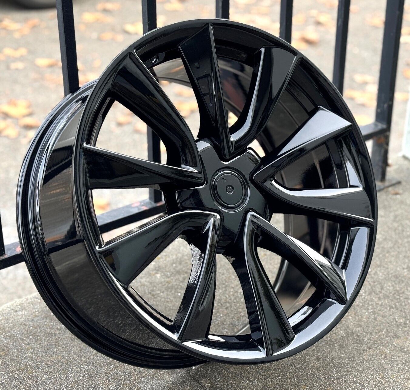 22-inch gloss black OE Style Wheels automotive rims fitting Tesla Model S and X, shown mounted on vehicle with sleek finish.