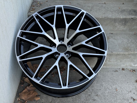 Black machined 21-inch RS Spyder style wheels by OE Style Wheels on a Porsche Macan, showcasing the sleek multi-spoke design.