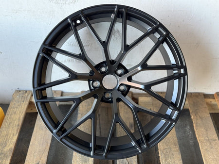 21-inch RS Spyder style matte black wheels by OE Style Wheels on a Porsche Macan, showcasing a sleek, sporty design.