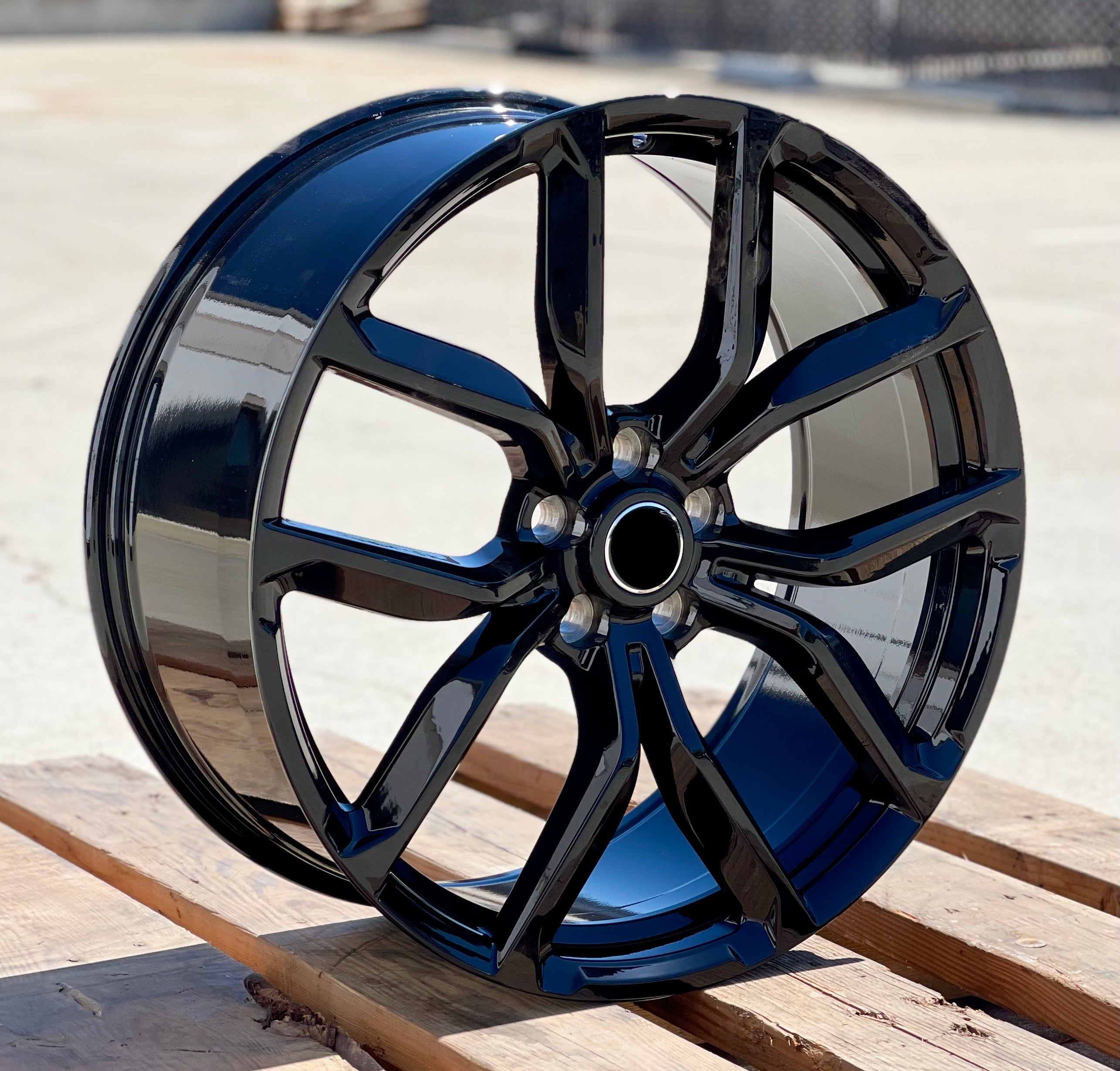22-inch SVR Style gloss black wheels by OE Style Wheels on Range Rover Evoque and Velar, showcasing sleek automotive rims.